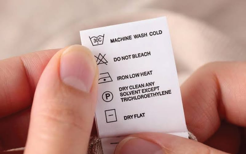 Garment care label with wash-instruction symbols