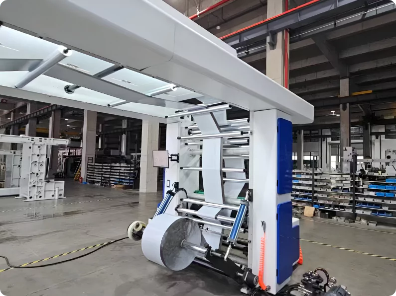 Flexographic printing press running brand artwork onto poly film — stage three of mailer manufacturing